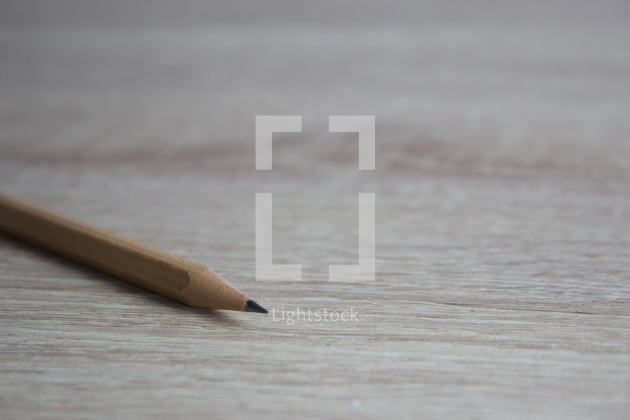 sharpened pencils on a wood background 