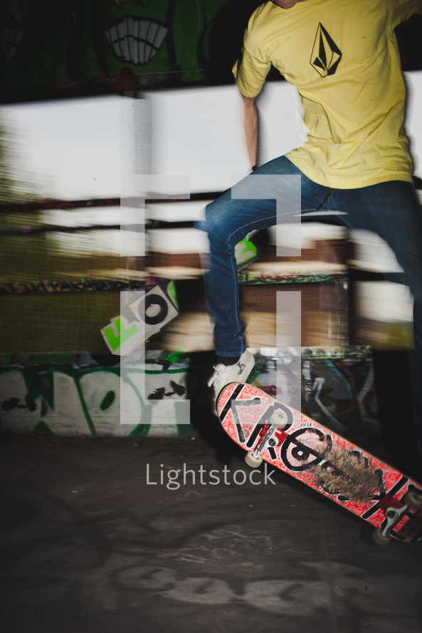 teen boy doing a trick on a skateboard 