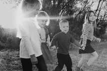 children holding hands outdoors 