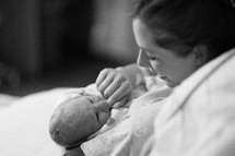 Mother holding newborn infant.