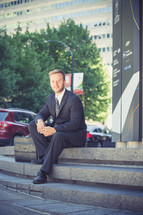 portrait of a businessman sitting on steps 