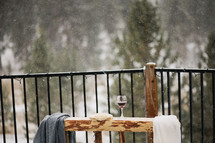 communion wine and bread on outdoor altar under snow fall