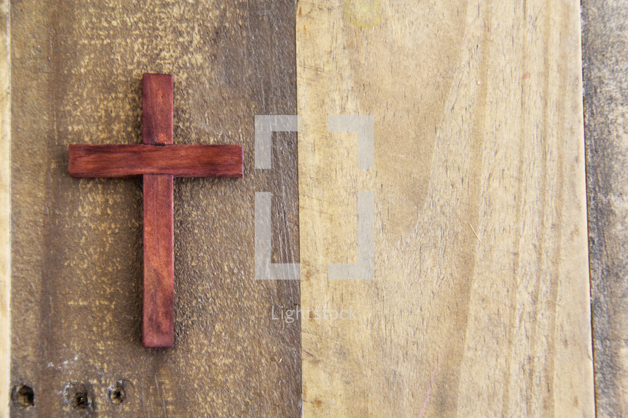 wooden cross on a wood floor 