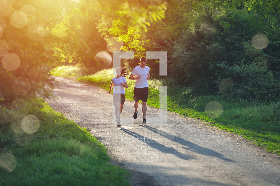 couple jogging on a path outdoors 
