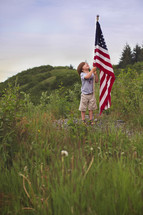 boy child holding an American flag 
