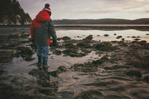 boy child standing in a tide pool 