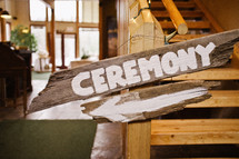 words CEREMONY painted on a wood sign
