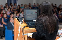 Young business woman during a slide show.