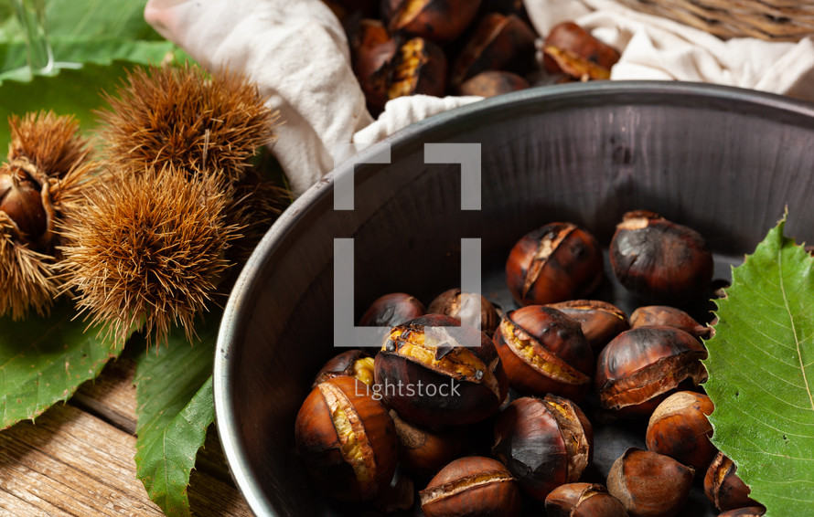 Roasted chestnuts in a pitted pan