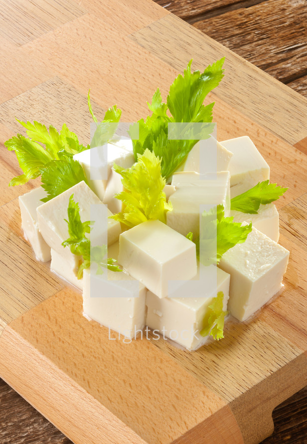 fresh Tofu cubes on wooden cutting board
