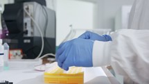 Scientist examining frozen samples takes out of deep freezing in a lab
