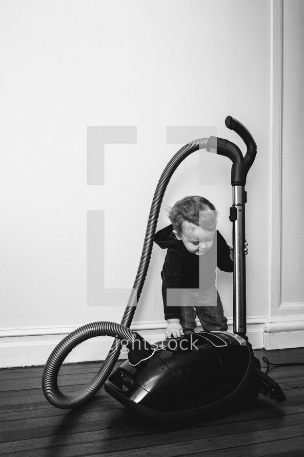toddler with a vacuum 