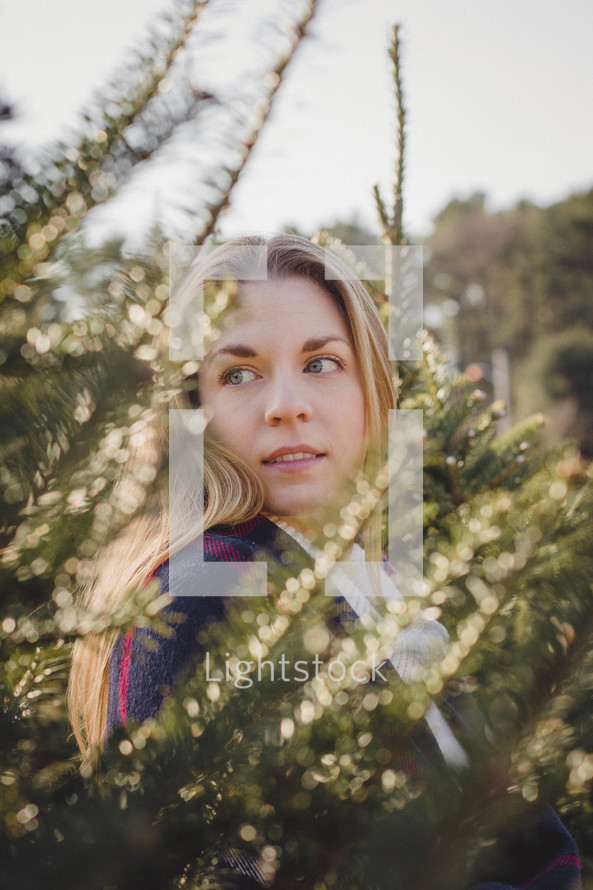 woman in a Christmas tree lot 
