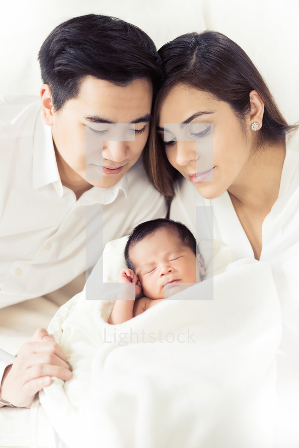 Couple with their newborn infant.