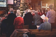 congregation singing hymns at a Christmas worship service 