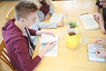 youth reading Bibles at a Bible study