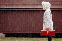 a woman holding a toolbox in the rain 