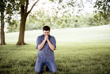 a man praying outdoors 