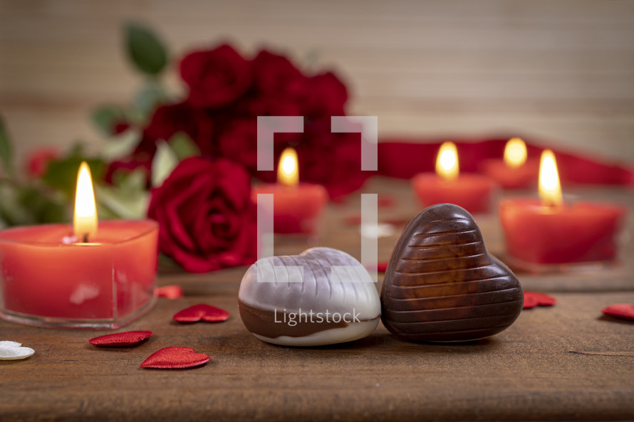 Valentines Day concept chocolate candies and red roses with candles