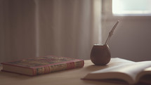 a book and pipe on a desk 