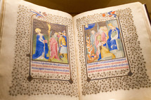 colorful artwork on the pages of an old Bible 