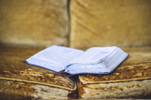 open BIble on a couch 
