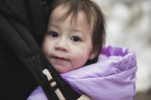 infant in a baby carrier 