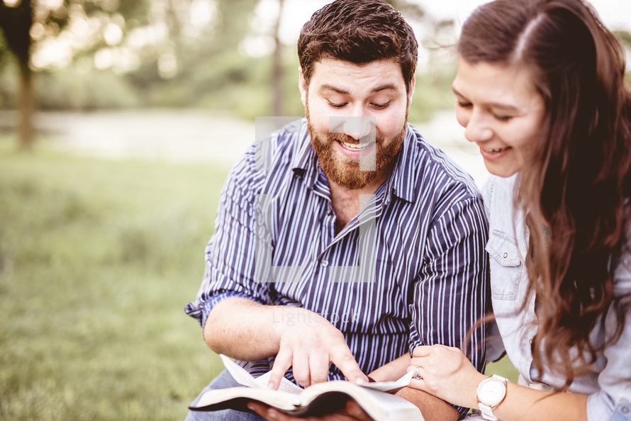 couple reading the Bible and praying together 