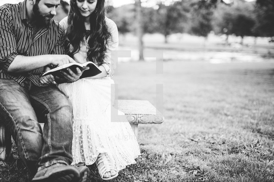 couple reading the Bible and praying together 