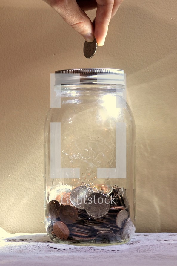 putting coins in a mason jar 