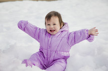 infant playing in snow 
