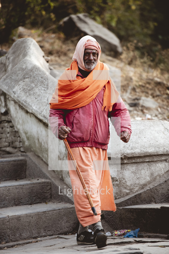 elderly man walking down steps in Nepal 