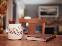 coffee mug and Bible on a wood table 
