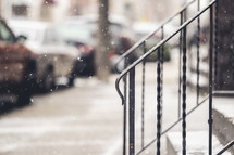 falling snow on a city sidewalk 