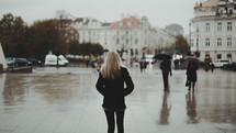 a woman walking outdoors on a rainy day 