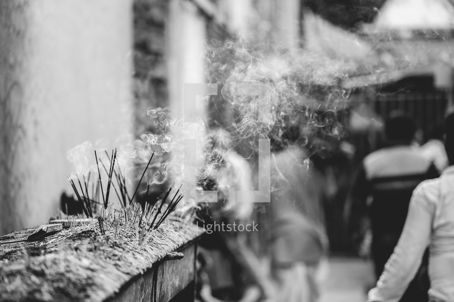 Incense burning at the Taraknath Hindu temple in India in black and white.