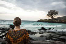 woman staring out at the water on an African Beach