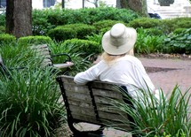 a woman sitting on a bench relaxing 