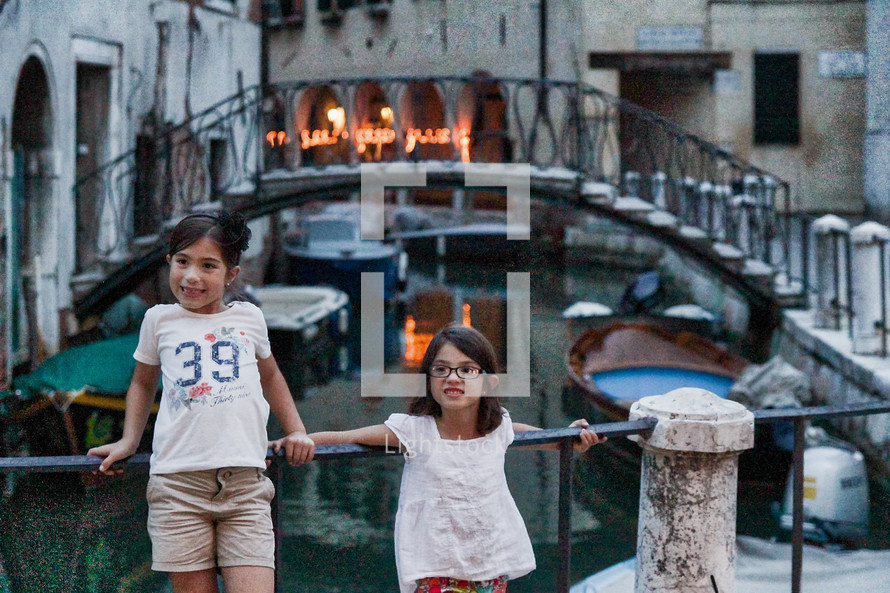 children posing in front of a canal in Venice 