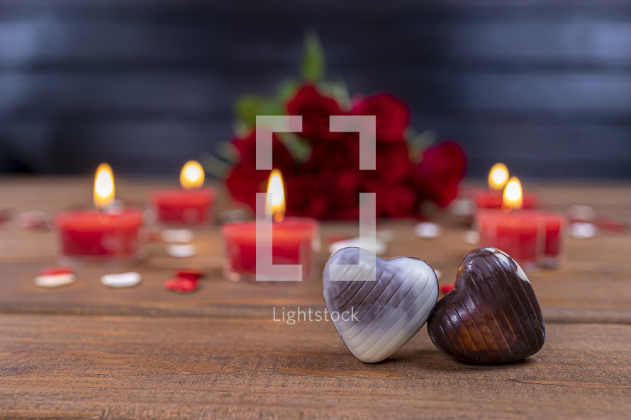 Valentines Day concept chocolate candies and red roses with candles	
