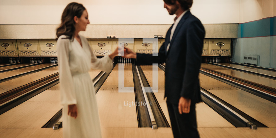 bride and groom in a bowling alley 