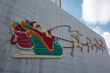 Light up Santa's sleigh on side of a building