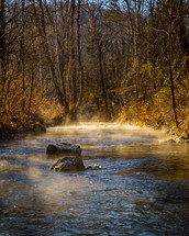 steam rising over a river on a cold morning 