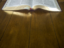 an open Bible on a floor