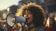 Portrait of afro american woman shouting loud holding a megaphone in urban background.