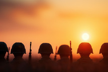 Veterans Day tribute featuring silhouetted soldiers at sunset, honoring military service and sacrifice with a warm, reflective scene.