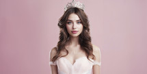 Enchanting young woman with a crown and elegant waves, exuding royalty.