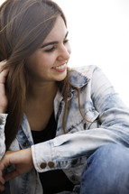 A teen girl looking relaxed and happy. 