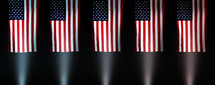 rows of American flags illuminated by spotlights 
