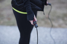 A woman preparing to jump rope.